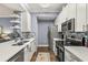 Modern galley kitchen with white cabinets and quartz countertops at 17104 Carrington Park Dr # 520, Tampa, FL 33647