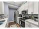 Modern kitchen with white cabinets, stainless steel appliances, and quartz countertops at 17104 Carrington Park Dr # 520, Tampa, FL 33647