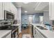 Open kitchen with island, stainless steel appliances, and blue walls at 17104 Carrington Park Dr # 520, Tampa, FL 33647