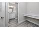 Modern bathroom with white vanity, gray tile floor, and built-in desk at 4093 Cadence Loop, Land O Lakes, FL 34638