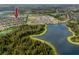 Aerial view showing home location in a community with a lake at 4093 Cadence Loop, Land O Lakes, FL 34638