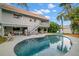 Stunning kidney-shaped pool and patio area with a view of the house at 1118 2Nd S Ave, Tierra Verde, FL 33715