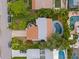 Aerial view of a single-Gathering home with a pool and lush landscaping at 1118 2Nd S Ave, Tierra Verde, FL 33715