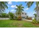 Modern two-story home with a gray exterior and nicely landscaped lawn at 1118 2Nd S Ave, Tierra Verde, FL 33715