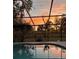 Relaxing screened-in pool area with sunset view at 8945 Overlook Dr, Wesley Chapel, FL 33545
