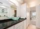 Bright modern bathroom with a sleek vanity, vessel sinks, and ample storage space, seamlessly connecting to the bedroom at 51 Island Way # 1107, Clearwater Beach, FL 33767