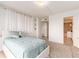 Bright bedroom with a comfortable bed, minimalist decor, and a glimpse into the elegant en-suite bathroom at 51 Island Way # 1107, Clearwater Beach, FL 33767
