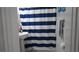 Bathroom featuring pedestal sink, navy-striped shower curtain, and bright natural light at 5805 Oxford Dr, Tampa, FL 33615