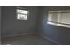 Neutral bedroom with tile flooring features two windows bringing in natural light at 5805 Oxford Dr, Tampa, FL 33615