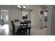Dining room features a table set for six and a view into the living room and kitchen at 5805 Oxford Dr, Tampa, FL 33615