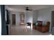 A serene living room featuring tile floors, ceiling fan, and a comfortable leather recliner at 5805 Oxford Dr, Tampa, FL 33615