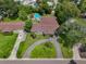 Single-Gathering home with pool and circular driveway, surrounded by lush landscaping at 831 72Nd N Ave, St Petersburg, FL 33702