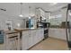 Modern kitchen with white cabinets, granite counters, and stainless steel appliances at 831 72Nd N Ave, St Petersburg, FL 33702