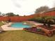 Inviting kidney-shaped pool with brick coping and a spacious patio area at 2321 Rothenfeld Ct, Land O Lakes, FL 34639
