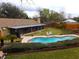 Aerial view showing home, pool, and fenced backyard at 2321 Rothenfeld Ct, Land O Lakes, FL 34639