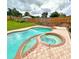 Relaxing pool and spa area with brick pavers at 2321 Rothenfeld Ct, Land O Lakes, FL 34639