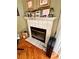 Fireplace with white tile surround and wood mantel at 2321 Rothenfeld Ct, Land O Lakes, FL 34639