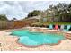 Large freeform swimming pool with tiled coping and comfortable lounge chairs at 2321 Rothenfeld Ct, Land O Lakes, FL 34639
