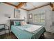 Bedroom with a queen bed, window with shutters, and hardwood floors at 4530 Flounder Dr, Hernando Beach, FL 34607