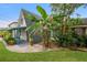 A-frame home with teal accents and tropical plants at 4530 Flounder Dr, Hernando Beach, FL 34607