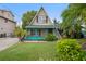 A-frame home with teal accents and manicured lawn at 4530 Flounder Dr, Hernando Beach, FL 34607