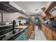 Modern kitchen with wood cabinets, stainless steel appliances, and a breakfast bar at 4530 Flounder Dr, Hernando Beach, FL 34607