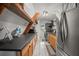 Modern kitchen with wood cabinets, dark countertops, and open shelving at 4530 Flounder Dr, Hernando Beach, FL 34607