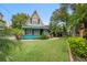 A-frame home with teal accents, lush landscaping at 4530 Flounder Dr, Hernando Beach, FL 34607