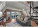 A cozy living room with water views, comfy seating, and a spiral staircase at 4530 Flounder Dr, Hernando Beach, FL 34607