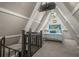 A cozy loft bedroom with a queen bed and a TV at 4530 Flounder Dr, Hernando Beach, FL 34607