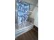 Updated bathroom with a bathtub and patterned shower curtain at 4530 Flounder Dr, Hernando Beach, FL 34607