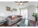 Living room with sectional sofa, coffee table, and wall art at 455 Alt 19 S # 175, Palm Harbor, FL 34683