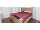 Main bedroom with wood floors and a red comforter at 455 Alt 19 S # 175, Palm Harbor, FL 34683