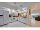 Bright kitchen with white cabinets, granite counters, and appliances at 6499 99Th N Way # 18B, St Petersburg, FL 33708