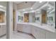 Elegant bathroom with double vanity and large mirror at 6499 99Th N Way # 18B, St Petersburg, FL 33708