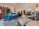 Spacious living room with teal sofa and armchairs, a view of the dining area at 6499 99Th N Way # 18B, St Petersburg, FL 33708