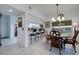 Bright dining area features a wood table with seating for four and a view into the kitchen at 6499 99Th N Way # 18B, St Petersburg, FL 33708