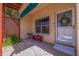 Private condo entrance with tiled patio and red bench at 6499 99Th N Way # 18B, St Petersburg, FL 33708