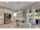Bright kitchen boasts white cabinets, stainless steel appliances, and a breakfast nook at 5608 Madrigal Way, Apollo Beach, FL 33572