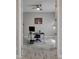 Home office with glass door, desk, chair, and neutral decor at 5608 Madrigal Way, Apollo Beach, FL 33572