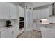 White kitchen with double ovens and pantry at 5608 Madrigal Way, Apollo Beach, FL 33572