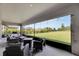 Spacious screened porch with wicker furniture and a fire pit at 5608 Madrigal Way, Apollo Beach, FL 33572