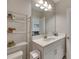 Small bathroom with white vanity and a tall storage shelf at 5608 Madrigal Way, Apollo Beach, FL 33572