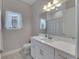 Clean bathroom with white vanity, shower, and window at 5608 Madrigal Way, Apollo Beach, FL 33572