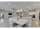 Open concept kitchen with a large island, white cabinets, and stainless steel appliances at 5608 Madrigal Way, Apollo Beach, FL 33572