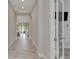 Long hallway with tile floors and neutral wall colors at 5608 Madrigal Way, Apollo Beach, FL 33572
