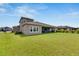 House backyard with green lawn at 5608 Madrigal Way, Apollo Beach, FL 33572