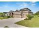 Two-story home with landscaped yard and two-car garage at 5608 Madrigal Way, Apollo Beach, FL 33572