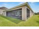Exterior view of a large screened porch overlooking the backyard at 5608 Madrigal Way, Apollo Beach, FL 33572