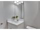Modern bathroom with white vanity, quartz countertop and a large mirror at 5608 Madrigal Way, Apollo Beach, FL 33572